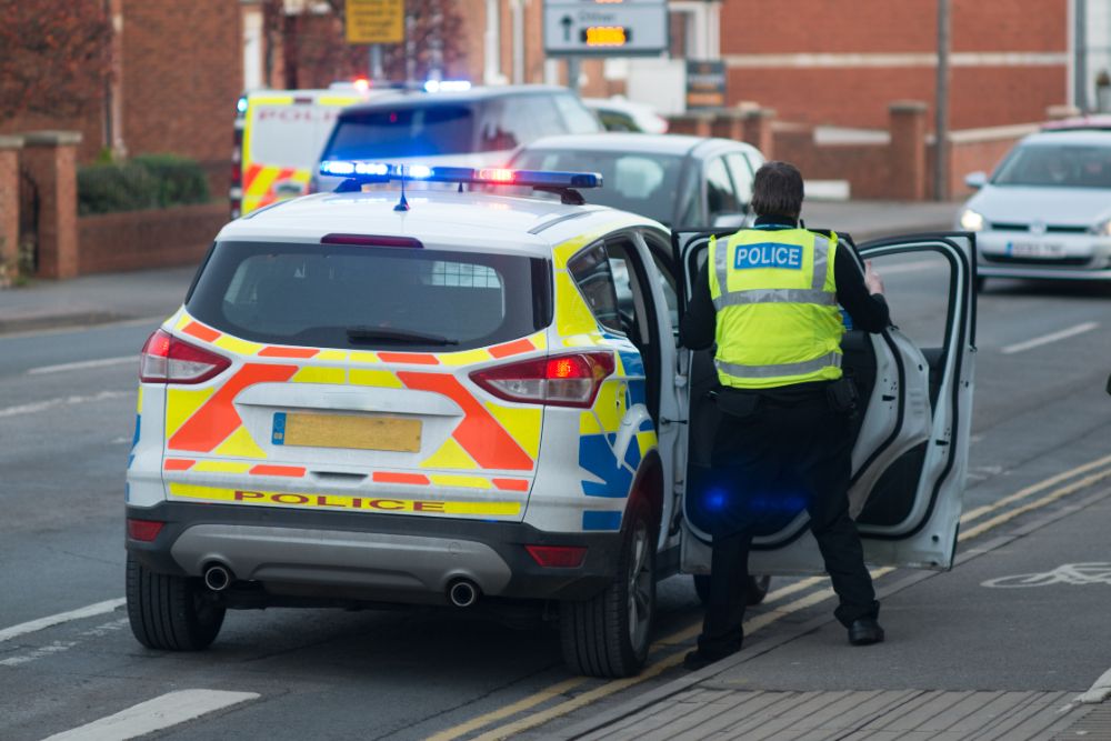 A pyramid scheme owner gets caught shows police car